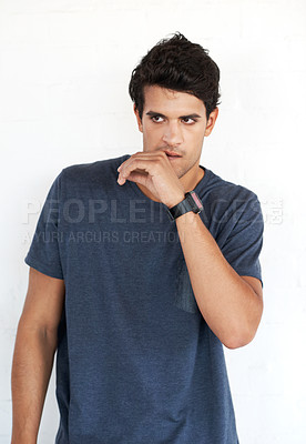 Buy stock photo Thinking, confident and man in studio for fashion with trendy outfit ideas and stylish clothes. White background, creative college student or Indian model with thoughts or cool casual tshirt in India