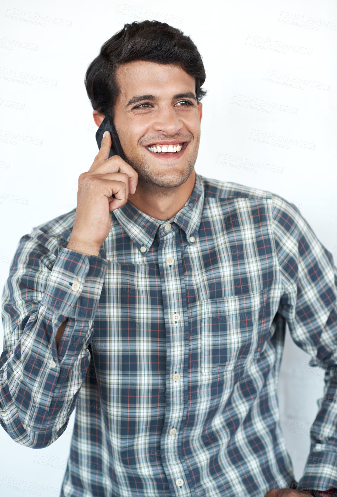 Buy stock photo Smile, phone call and creative designer in studio on white background for communication, networking and chat. Man, conversation and happy person speaking on smartphone for contact, discussion or talk