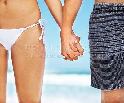 Buy stock photo Closeup, holding hands and couple at beach, summer and vacation together with love, support and bonding. People, care and holiday by ocean, solidarity and romantic walk by waves, sunshine and bikini