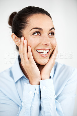 Buy stock photo Smiling businesswoman looking away with her hands on her face