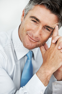 Buy stock photo Handsome mature businessman sitting and thinking with a smile