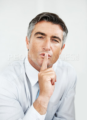 Buy stock photo Mature business with his finger on his lips