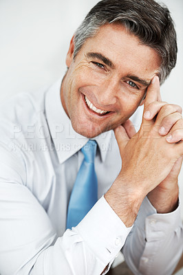 Buy stock photo Handsome mature businessman sitting and thinking with a smile