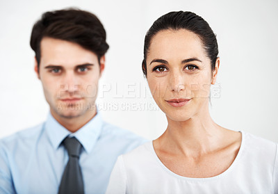 Buy stock photo Two serious young business colleagues standing together