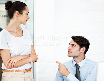 Buy stock photo Two young business colleagues having a disagreement at work