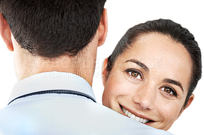 Buy stock photo Pretty young woman looking over her husband's shoulder with a smile