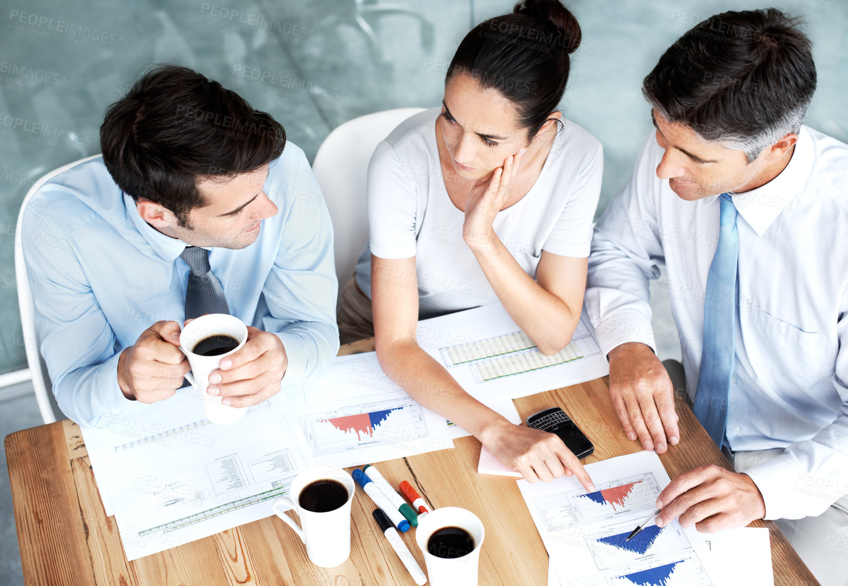 Buy stock photo Group of businesspeople working together on a project