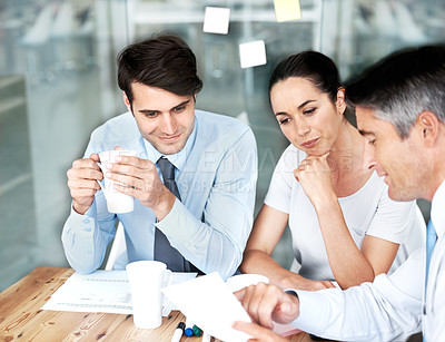 Buy stock photo Group of businesspeople working together on a project