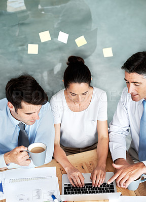 Buy stock photo Business people, team and typing on laptop in office for planning, collaboration and accounting. Men and woman together at desk with tech and paperwork for tax, budget or brainstorming strategy above