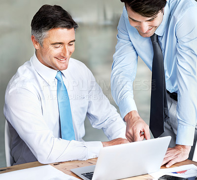 Buy stock photo Two businessmen working together on a project