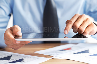 Buy stock photo Cropped view of a man's hands using a touchscreen tablet