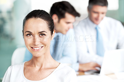 Buy stock photo Smiling young businesswoman sitting in a group meeting