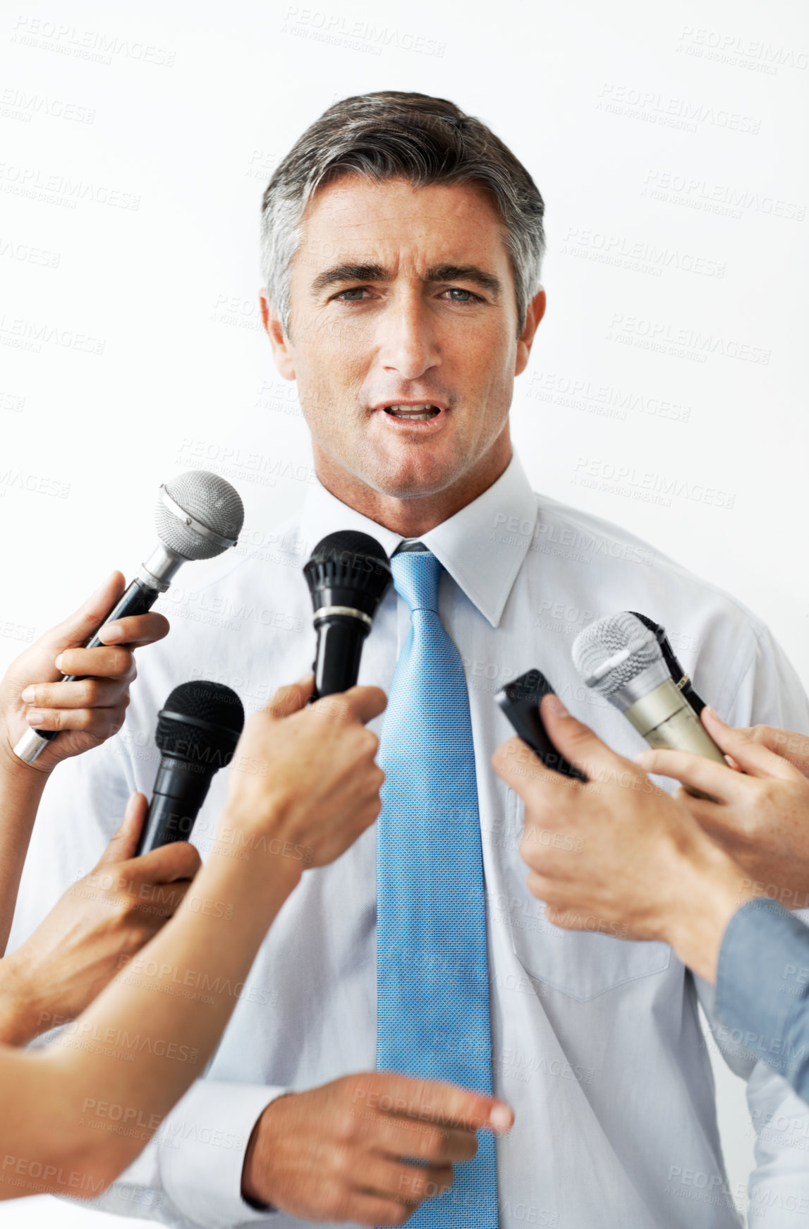 Buy stock photo Microphone, hands and portrait of businessman with talking in studio for press release. Confident, media and male attorney with reporters for legal publicity interview for client by white background.