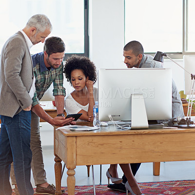 Buy stock photo A group of coworkers working together in the office