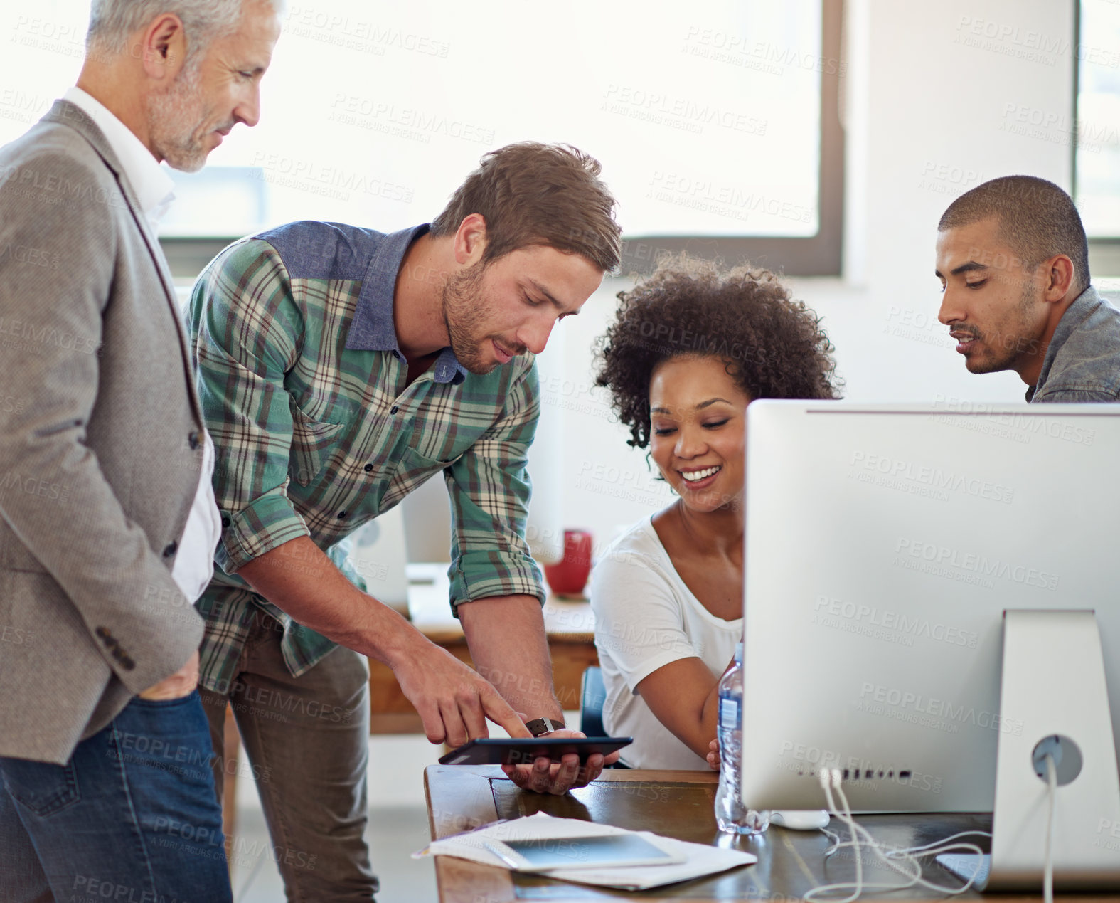 Buy stock photo A group of coworkers working together in the office
