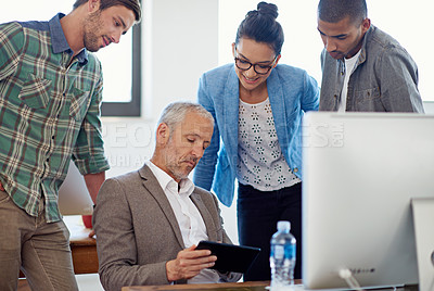 Buy stock photo A group of coworkers working together in the office