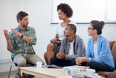 Buy stock photo Shot of a diverse group of designers having a meeting around a coffee table