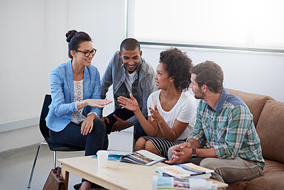Buy stock photo Shot of a group of designers having a meeting around a coffee table
