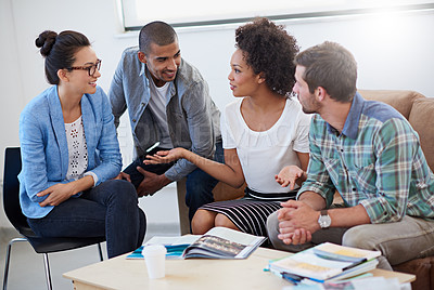 Buy stock photo Shot of a diverse group of designers having a meeting around a coffee table