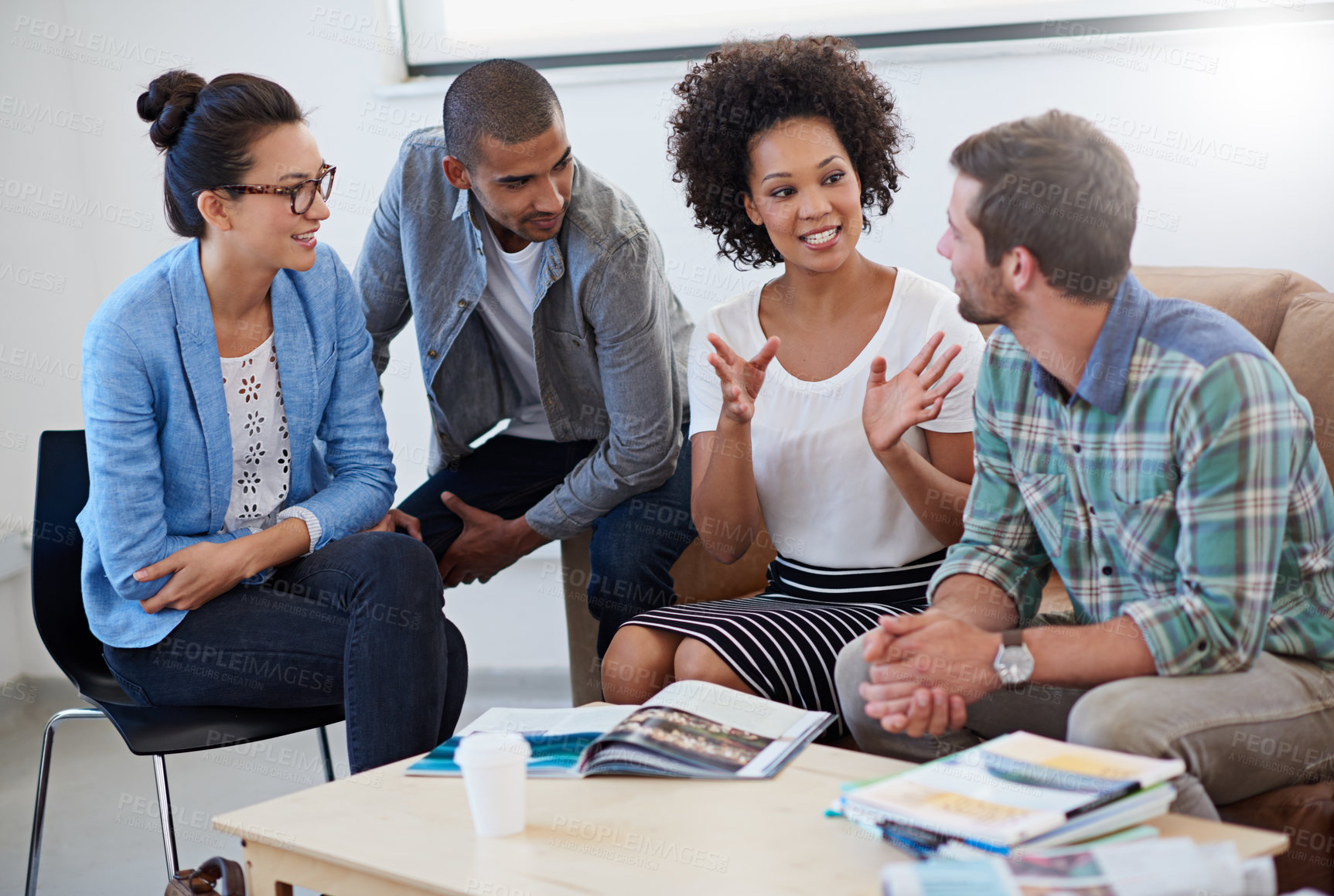 Buy stock photo Shot of a group of designers having a meeting around a coffee table