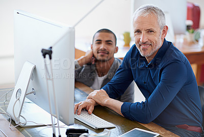 Buy stock photo Portrait of two colleagues sitting at a computer in the office