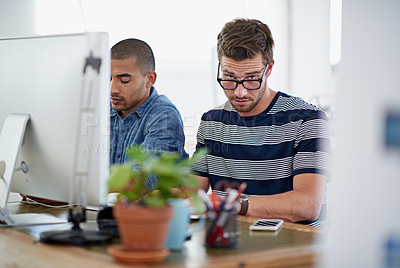 Buy stock photo Portrait of a designer working with a colleague on a computer in an office
