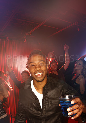 Buy stock photo A young handsome man having an awesome time while clubbing with his friends