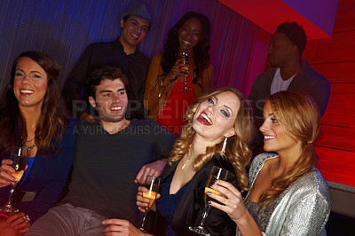 Buy stock photo A group of friends having drinks in a nightclub