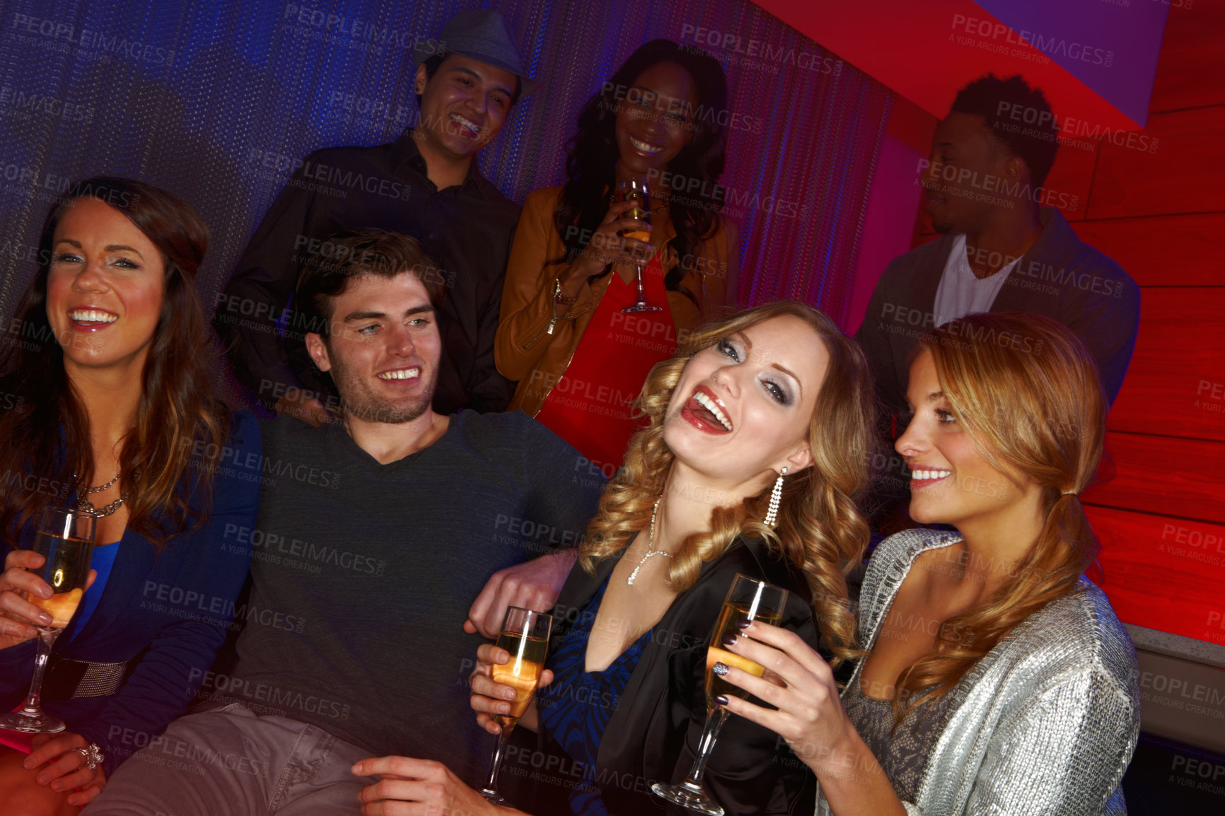 Buy stock photo A group of friends having drinks in a nightclub