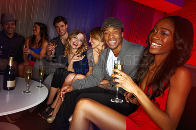 Buy stock photo A group of friends having drinks in a nightclub