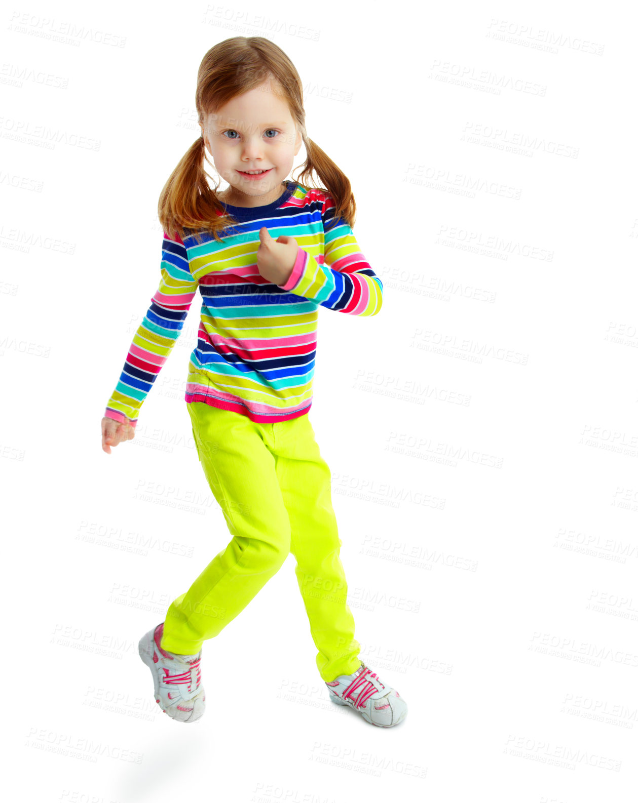 Buy stock photo Portrait of a playful little girl smiling and dancing while isolated against a white background