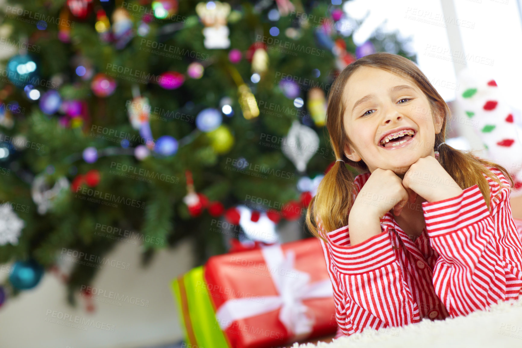 Buy stock photo Young girl, holiday celebration and Christmas morning at family home, ready for gift and happy with braces in portrait. Excited to celebrate, kid and happiness for present, Christmas tree decoration 