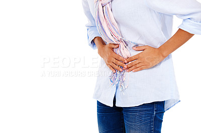 Buy stock photo Woman, stomach and pain in discomfort, ache or sore digestion against a white studio background. Isolated female holding belly or painful uncomfortable area suffering from cramps on white background