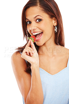Buy stock photo Beautiful young ethnic woman taking a bite of a fresh strawberry