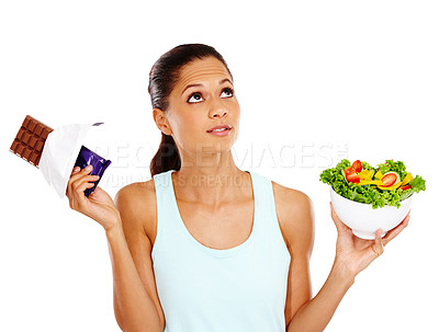 Buy stock photo Thinking, choice and woman with chocolate and salad in studio for healthy eating, wellness and nutrition. Decision, diet option and unsure person with vegetables, food and candy on white background