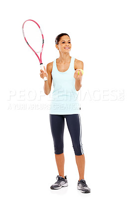 Buy stock photo Full length image of a happy young woman holding a tennis racket and ball getting ready to serve