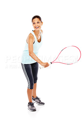 Buy stock photo Full length image of a happy young woman ready for her match while holding a tennis racket and ball