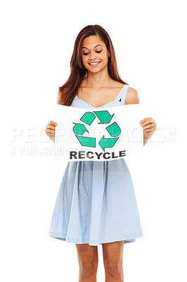 Buy stock photo Young woman smiling and holding up a poster with the recycling logo on it against a white background