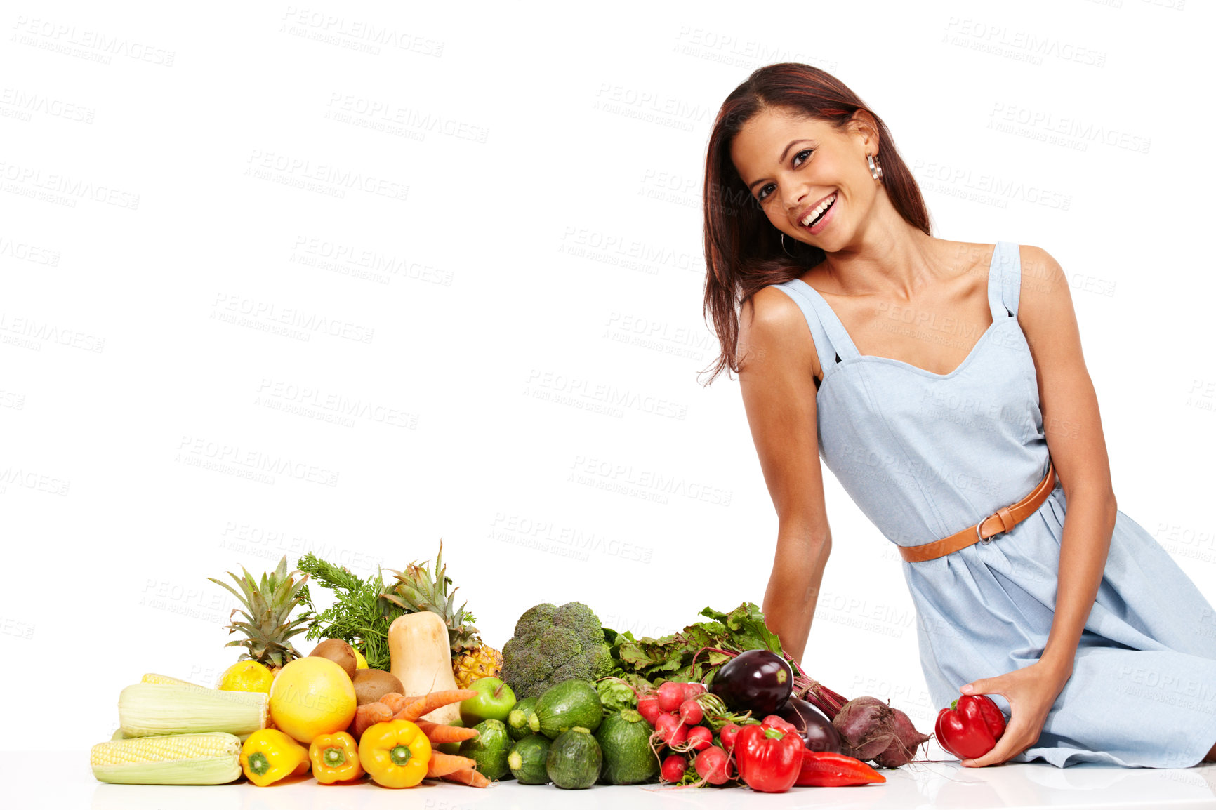 Buy stock photo Smiling young woman alongside an assortment of healthy and fresh vegetables