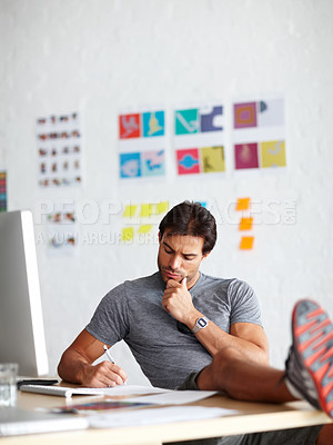 Buy stock photo Creative, man and writing at desk in office for project budget planning, ideas and information. Business, workplace and athletics administrator thinking with notes for report, feedback and solution