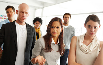 Buy stock photo Portrait of a group of coworkers looking skeptical