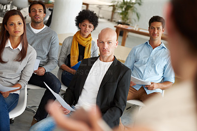 Buy stock photo A group of colleagues sitting in a business meeting