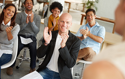 Buy stock photo A group of colleagues applauding while sitting in a business meeting