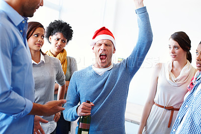 Buy stock photo Christmas, drunk and office party with a business man drinking while having fun with a colleague group at work. Music, alcohol and rude with a male employee acting crazy, bad and loud at a party