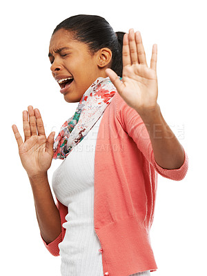 Buy stock photo A young woman looking scared and gesturing for you stop 