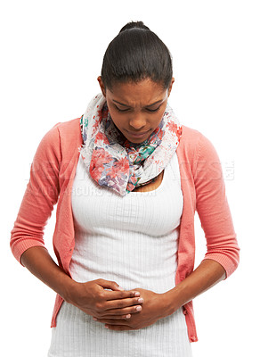 Buy stock photo Cramps, period pain and woman in studio with worry, hurt and injury on white background. Sick, abdominal and isolated person holding stomach for tummy ache, menstrual discomfort and constipation