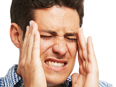 Buy stock photo A young man holding his head as a result of a splitting headache
