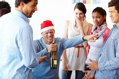 Buy stock photo A male employee having too much fun at the office party while his colleagues look on. Carefree excited diverse workers having fun riding celebrating Friday together, happy employees