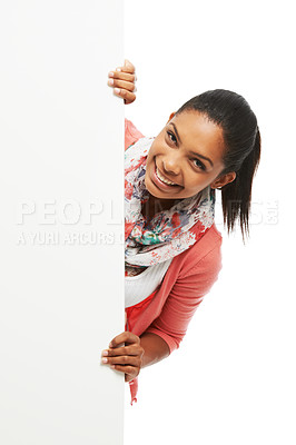 Buy stock photo Cute young woman peering around white copyspace while smiling