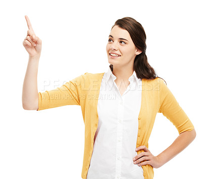 Buy stock photo Attractive young woman pointing upwards against a white background